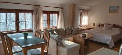 a living room with a couch and a bed at Citadel Guest House in Varna City