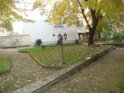 a street light in a park next to a building at Citadel Guest House in Varna City