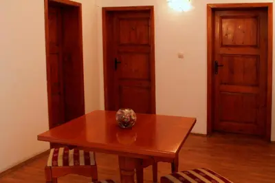 a wooden table with a vase on top of it at Citadel Guest House in Varna City