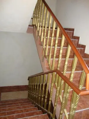 a wooden spiral staircase in a building at Guest House Perla in Obzor