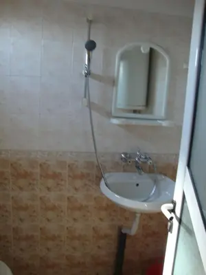 a bathroom with a sink and a shower at Guest House Perla in Obzor