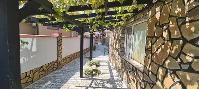 an empty alley with a stone building with a window at Sineva Guest House in Ravda