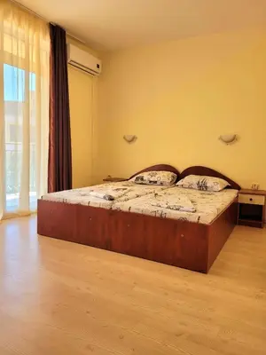a bedroom with a large bed in a room at Guesthouse Iceberg in Ravda