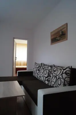 a living room with a couch and a window at Guesthouse Iceberg in Ravda