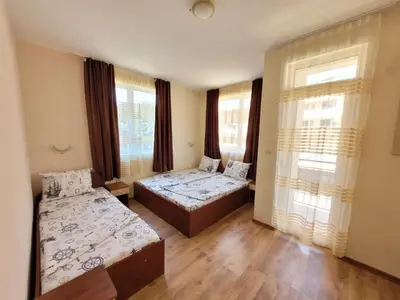 a room with two beds and a window at Guesthouse Iceberg in Ravda