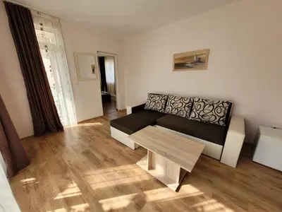 a living room with a couch and a table at Guesthouse Iceberg in Ravda