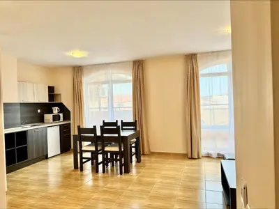 a kitchen and dining room with a table and chairs at Menada Sky Dreams Apartments in Sveti Vlas