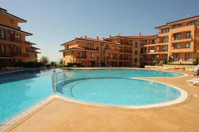 a large swimming pool in front of some apartment buildings at Menada Sky Dreams Apartments in Sveti Vlas