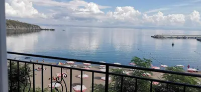 a view of a body of water with umbrellas at Вила Лазурен бряг in Chernomorets