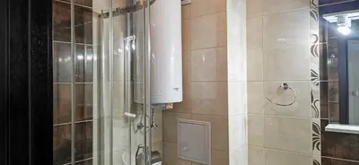 a bathroom with a shower and a water tank at Вила Лазурен бряг in Chernomorets