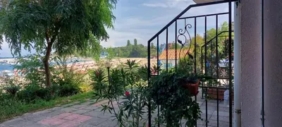 a iron gate with a view of a beach at Вила Лазурен бряг in Chernomorets