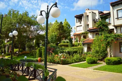 a street light in a garden with houses at Oasis Resort Lozenets in Lozenets