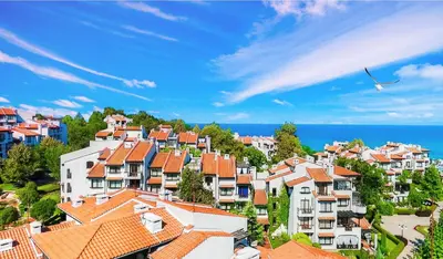 a group of houses on a hill near the ocean at Oasis Resort Lozenets in Lozenets
