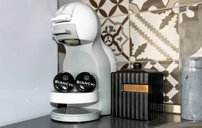 a white blender sitting on a counter next to a candle at Joy Apartment Burgas center free parking in Burgas City