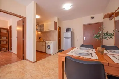 a kitchen and dining room with a table and chairs at Elit 4 Apartments in Sunny Beach