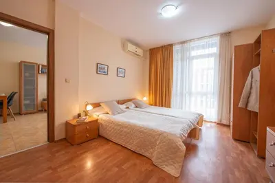 a bedroom with a large bed and a large window at Elit 4 Apartments in Sunny Beach