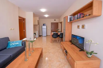 a living room with a couch and a tv at Elit 4 Apartments in Sunny Beach