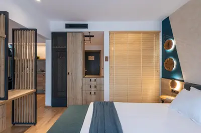 a bedroom with a large bed and a bathroom at Utopia Forest in Burgas City