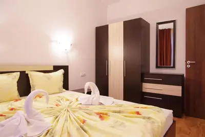 a bedroom with two swans on a bed at Cabana Beach Club Complex in Nesebar
