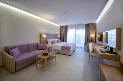 a large living room with a couch and a bed at Belvedere Hotel - All inclusive in Primorsko