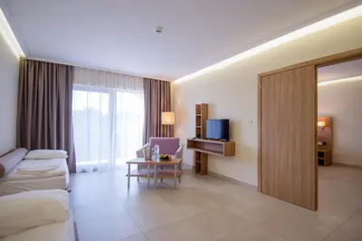 a hotel room with a couch and a table at Belvedere Hotel - All inclusive in Primorsko