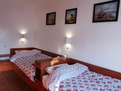 a bedroom with two beds and two pictures on the wall at INFINITY Blue 2 in Burgas City