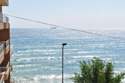 a street light in front of the ocean at Ivanka Guest House in Obzor