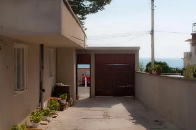 a door to a house with a view of the ocean at Ivanka Guest House in Obzor