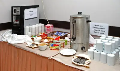 a table with food and drinks and a coffee machine at Hotel Yunona - All Inclusive in Sunny Beach