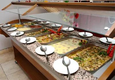 a buffet line with many different types of food at Hotel Yunona - All Inclusive in Sunny Beach