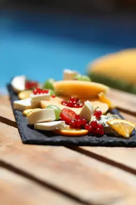 a black plate with different types of food on it at Salena Beach Hotel in Primorsko