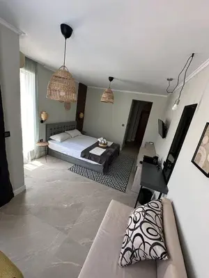 a living room with a bed and a couch at Salena Beach Hotel in Primorsko