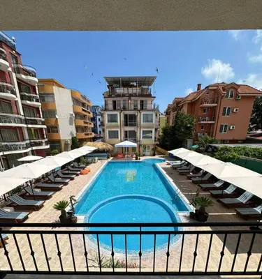 a view of a swimming pool from a balcony with umbrellas at Salena Beach Hotel in Primorsko