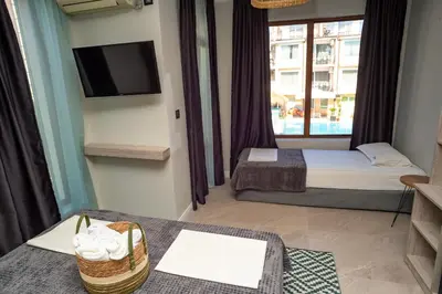 a hotel room with two beds and a television at Salena Beach Hotel in Primorsko