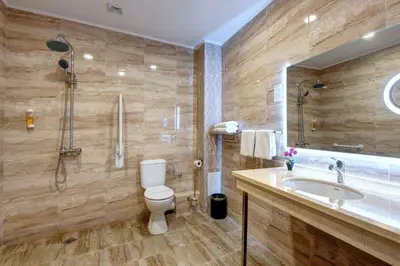 a bathroom with a toilet and a sink and a shower at Maria Palace Hotel - All Inclusive in Sunny Beach