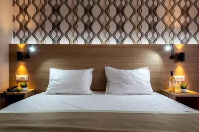a bedroom with a large bed with white pillows at Maria Palace Hotel - All Inclusive in Sunny Beach