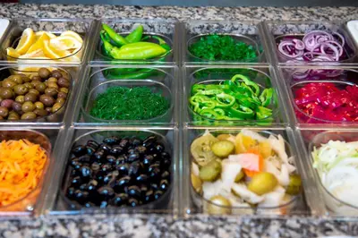 a plastic container filled with different types of vegetables at Maria Palace Hotel - All Inclusive in Sunny Beach