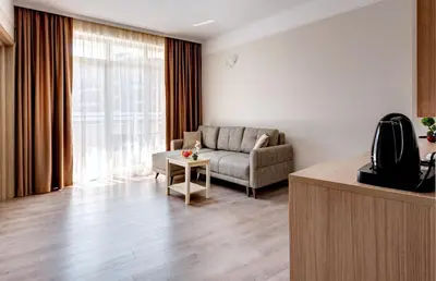 a living room with a couch and a table at Maria Palace Hotel - All Inclusive in Sunny Beach