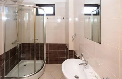 a bathroom with a shower and a toilet and a sink at Seaside Garden Apartment with 2 BR for up to 5 pax in Sunny Beach