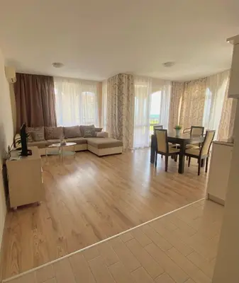 a living room with a couch and a table at Apartments in complex ATIA RESORT in Chernomorets