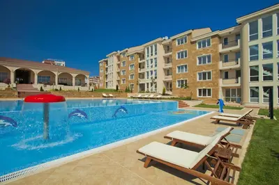 a swimming pool with a fountain and some buildings at Apartments in complex ATIA RESORT in Chernomorets