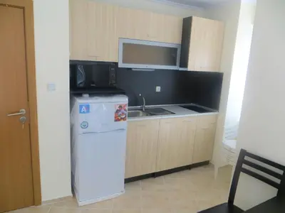 a kitchen with a white refrigerator and a microwave at Apartments in Azalia 2 Complex in Nesebar