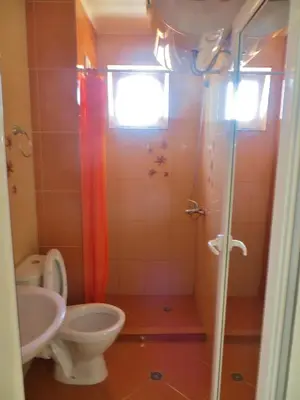 a bathroom with a toilet and a sink and a shower at Apartments in Azalia 2 Complex in Nesebar