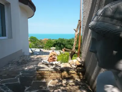 a statue sitting on the side of a building at Villa Sky Music in Obzor