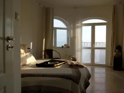 a bedroom with a bed with two windows and a bed sidx sidx sidx at Villa Sky Music in Obzor