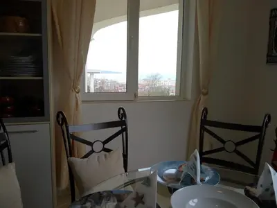 a dining room with a glass table and a window at Villa Sky Music in Obzor