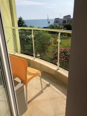 a balcony with a chair and a view of the ocean at Villa St Anna in Sozopol