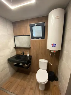 a bathroom with a toilet and a sink at Бунгала Виктория - Камчия in Kamchia