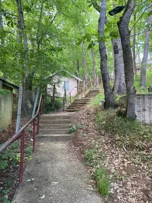 a set of stairs in a park with trees at Бунгала Виктория - Камчия in Kamchia