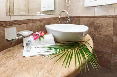 a bathroom with a sink and a palm tree at Sunny Paradise ll in Kiten